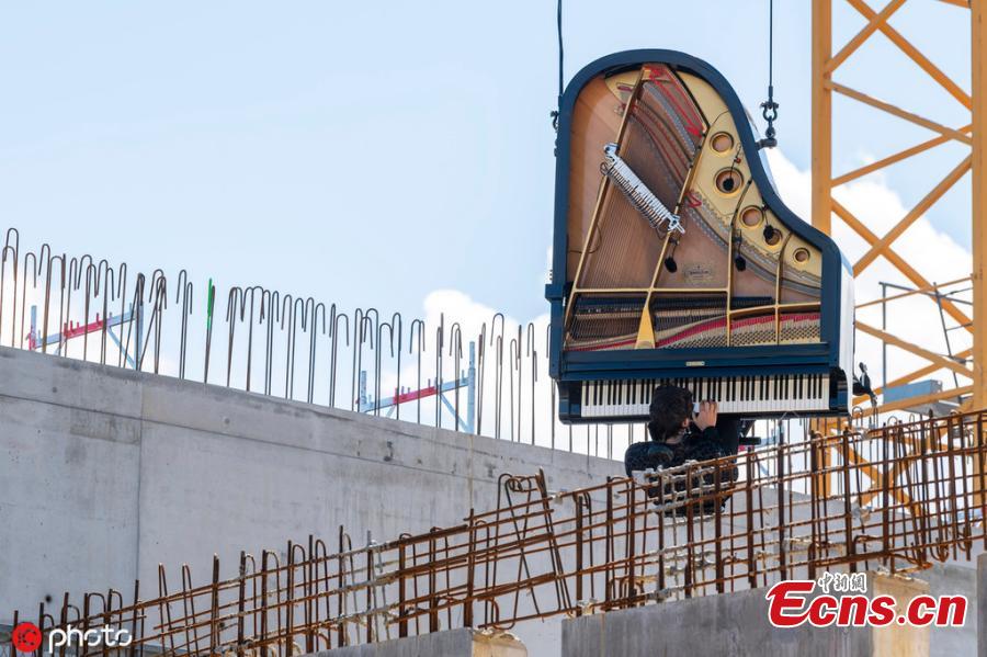 Pianist-composer Alain Roche played his vertical piano during a performance on the occasion of an Open Day at the construction site of the future Theatre de Carouge, in Carouge near Geneva, Switzerland, Sunday, June 15, 2019. (Photo/IC)