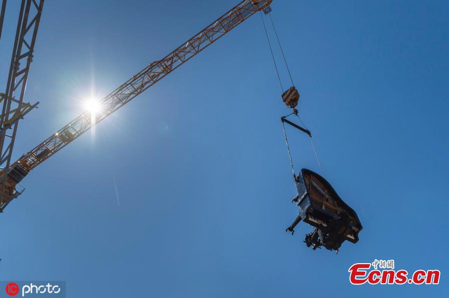 Pianist-composer Alain Roche played his vertical piano during a performance on the occasion of an Open Day at the construction site of the future Theatre de Carouge, in Carouge near Geneva, Switzerland, Sunday, June 15, 2019. (Photo/IC)