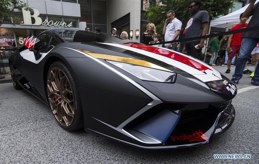 People visit the 2019 Yorkville Exotic Car Show in Toronto, Canada, June 16, 2019. More than 110 classic and exotic cars were displayed at the annual Father\'s Day event on Sunday, attracting tens of thousands of visitors. (Xinhua/Zou Zheng)
