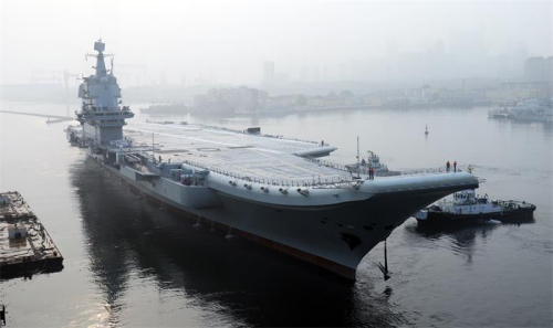 China’s first domestically designed aircraft carrier, which displaces 50,000 metric tons, leaves the Dalian Shipbuilding Industry’s shipyard in Liaoning province on Sunday. (LI GANG/FOR CHINA DAILY) China’s first domestically designed aircraft carrier, which displaces 50,000 metric tons, leaves the Dalian Shipbuilding Industry’s shipyard in Liaoning province on Sunday. (LI GANG/FOR CHINA DAILY)